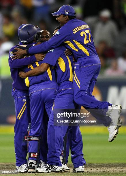 Sanath Jayasuriya of Sri Lanka is congratulated by team mates after bowling Brett Lee of Australia to win the match during the Commonwealth Bank...