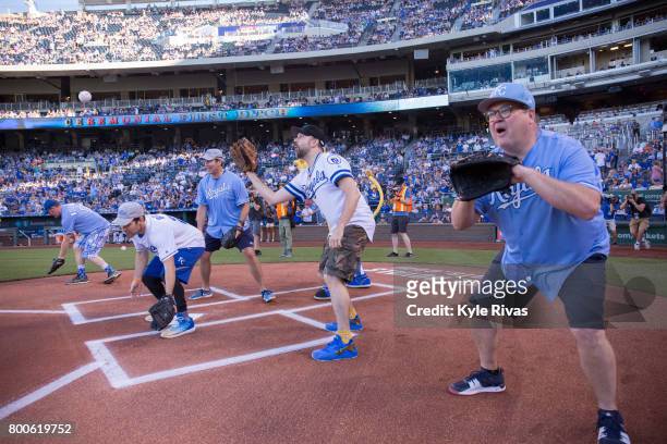 Eric Stonestreet, Jason Sudeikis, Paul Rudd, Rob Riggle and David Koechner catch the first pitch during the Big Slick Celebrity Weekend benefitting...