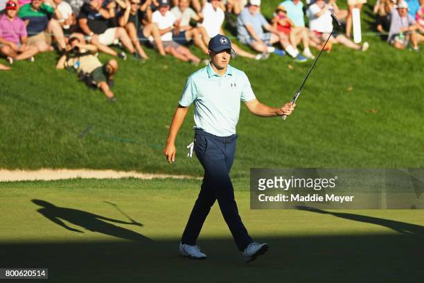 Jordan Spieth of the United States reacts after putting on the 18th green during the third round of the Travelers Championship at TPC River Highlands...