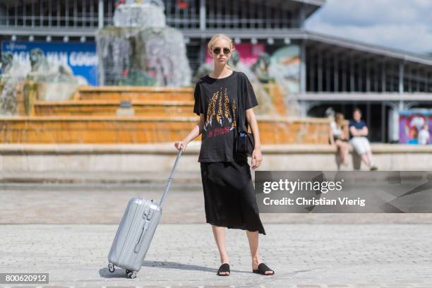 Model with a trolley outside Sacai during Paris Fashion Week Menswear Spring/Summer 2018 Day Four on June 24, 2017 in Paris, France.