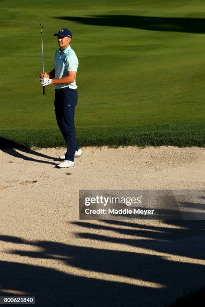 Jordan Spieth of the United States watches his second shot on the 18th hole during the third round of the Travelers Championship at TPC River...