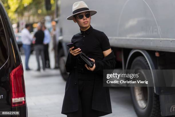 Guest wearing hat, black polo shirt outside Hermes during Paris Fashion Week Menswear Spring/Summer 2018 Day Four on June 24, 2017 in Paris, France.