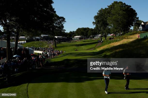 Jordan Spieth and Patrick Reed of the United States walk to the 18th tee during the third round of the Travelers Championship at TPC River Highlands...