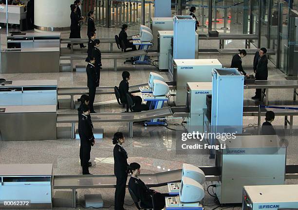 Airport employees carry out safety inspections at the new terminal building T3 at the Beijing Capital International Airport February 29, 2008 in...