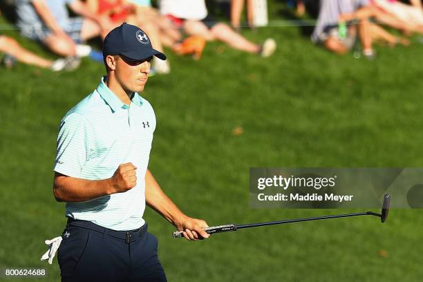 Jordan Spieth of the United States reacts after putting on the 18th green during the third round of the Travelers Championship at TPC River Highlands...