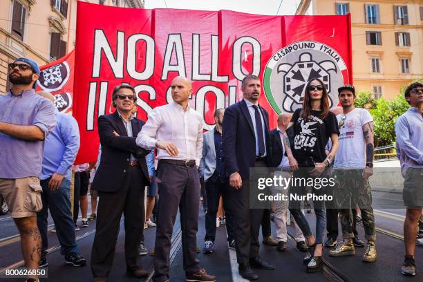 Simone Di Stefano, Casapound Vice President, and Nina Moric , a Croatian fashion model, march as thousands of members of Italian far-right movement...