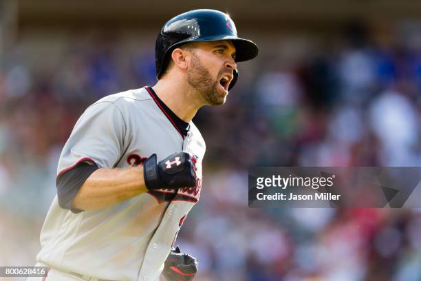 Brian Dozier of the Minnesota Twins celebrates as he rounds the bases on a solo home run to take the lead during the eighth inning against the...