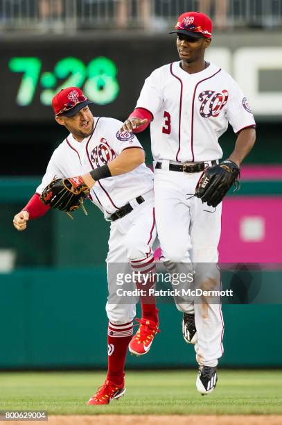Ryan Raburn and Michael Taylor of the Washington Nationals celebrate after the Nationals defeated the Cincinnati Reds 18-3 during a game at Nationals...