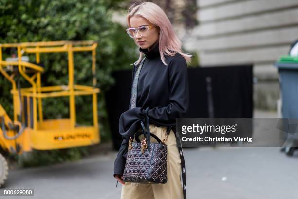 Julia Kuczynska wearing beige cropped pants, Chanel shoes, net tights outside Dior Homme during Paris Fashion Week Menswear Spring/Summer 2018 Day...