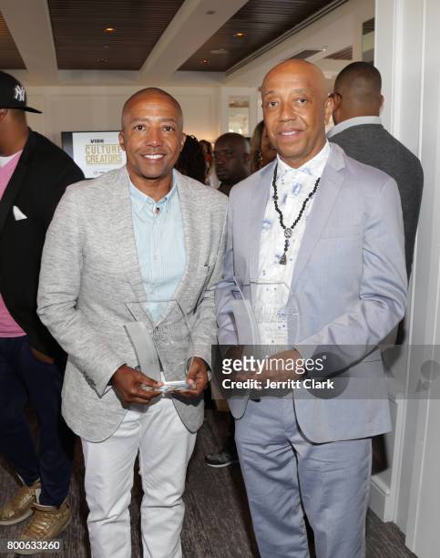 Music Moguls Kevin Liles and Russell Simmons pose with their awards during the Culture Creators 2nd Annual Awards Brunch Presented By Motions Hair...
