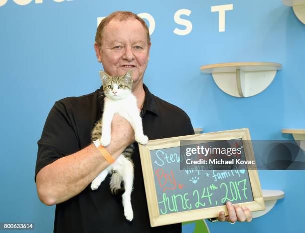 Stewie the cat with his new owner at the grand opening of The Wallis Annenberg PetSpace on June 24, 2017 in Playa Vista, California.