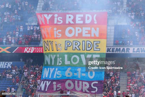 New York Red Bulls fans raise a rainbow Pride banner prior to the first half of the Major League Soccer game between the New York Red Bulls and New...