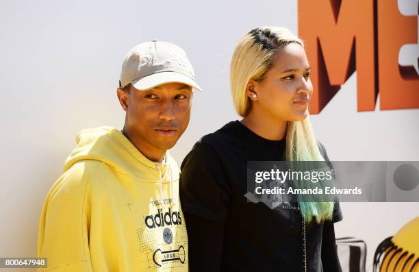 Singer Pharrell Williams and Helen Lasichanh arrive at the premiere of Universal Pictures and Illumination Entertainment's "Despicable Me 3" at The...