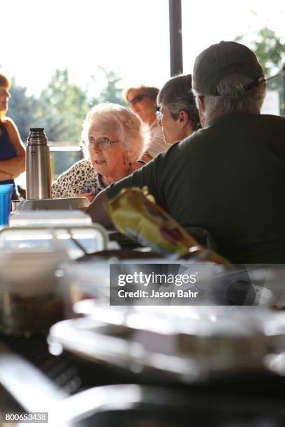 Community members enjoy conversation during the MoveOn Resistance Summer Community Potluck at Martin Park on June 24, 2017 in Boulder, Colorado.
