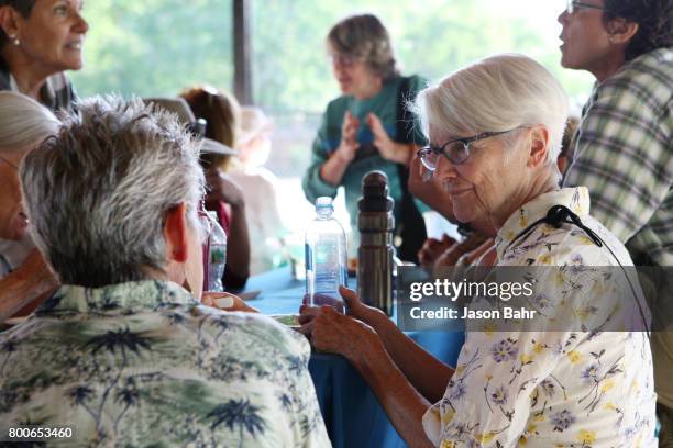 Community members enjoy conversation during the MoveOn Resistance Summer Community Potluck at Martin Park on June 24, 2017 in Boulder, Colorado.