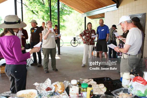 Community members sing together during the MoveOn Resistance Summer Community Potluck at Martin Park Shelter on June 24, 2017 in Boulder, Colorado.
