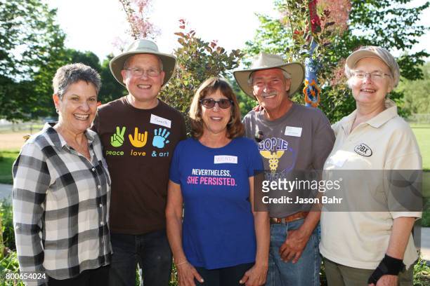 Organizers Cristina Aguilera, Kenneth Nova, Wendy Rochman, Geof Cahoon, and Louise Knapp smile during the MoveOn Resistance Summer Community Potluck...