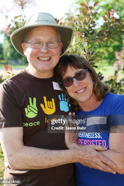 Husband and wife team Kenneth Nova and Wendy Rochman smile after oganizing the MoveOn Resistance Summer Community Potluck at Martin Park on June 24,...