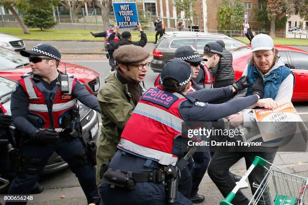 Police and protesters clash on June 25, 2017 in Melbourne, Australia. An anti racist rally was organised to counter an 'Australian pride march' held...