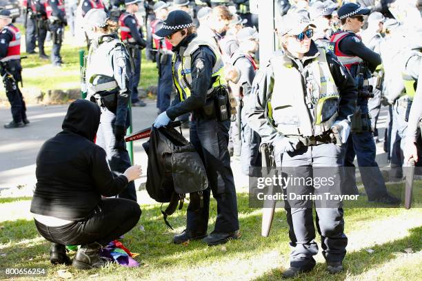 Police search protesters on June 25, 2017 in Melbourne, Australia. An anti racist rally was organised to counter an 'Australian pride march' held by...