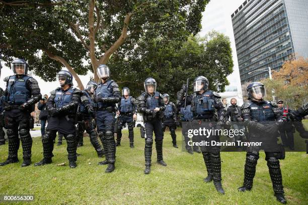 Members of Victoria Police Public Order Response team keep watch on June 25, 2017 in Melbourne, Australia. An anti racist rally was organised to...