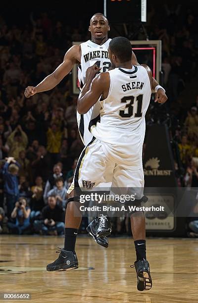 Williams and Jamie Skeen of the Wake Forest Demon Deacons celebrate at a time out veruss the Duke Blue Devils at the LJVM Coliseum on February 17,...