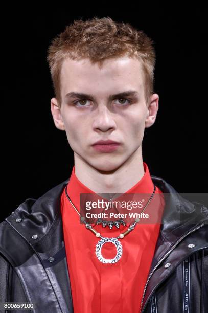 Model, jewel detail, walks the runway during the Dior Homme Menswear Spring/Summer 2018 show as part of Paris Fashion Week on June 24, 2017 in Paris,...