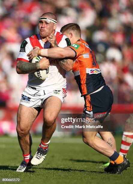 Russell Packer of the Dragons is tackled during the round 16 NRL match between the St George Illawarra Dragons and the Newcastle Knights at UOW...