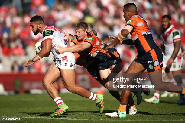 Hame Sele of the Dragons is tackled during the round 16 NRL match between the St George Illawarra Dragons and the Newcastle Knights at UOW Jubilee...
