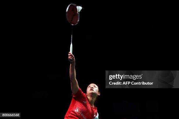 Nozomi Okuhara of Japan hits a return against compatriot Akane Yamaguchi in the Australian Open women's singles badminton final in Sydney on June 25,...