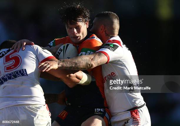 Lachlan Fitzgibbon of the Knights is tackled during the round 16 NRL match between the St George Illawarra Dragons and the Newcastle Knights at UOW...