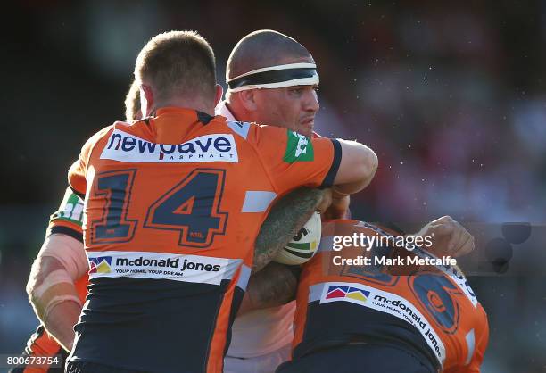 Russell Packer of the Dragons is tackled during the round 16 NRL match between the St George Illawarra Dragons and the Newcastle Knights at UOW...