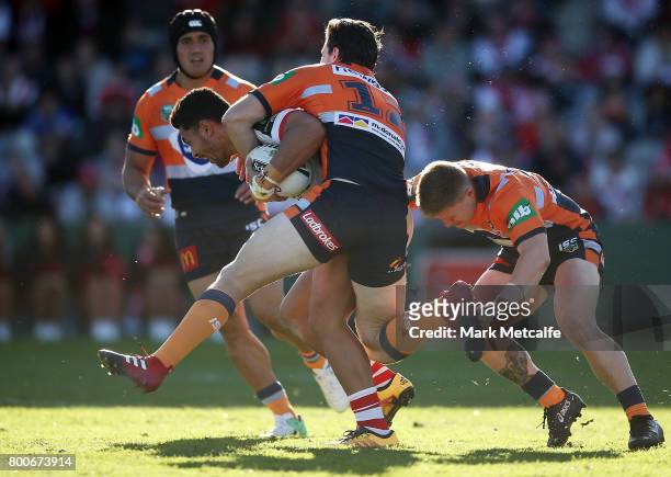 Hame Sele of the Dragons is tackled during the round 16 NRL match between the St George Illawarra Dragons and the Newcastle Knights at UOW Jubilee...