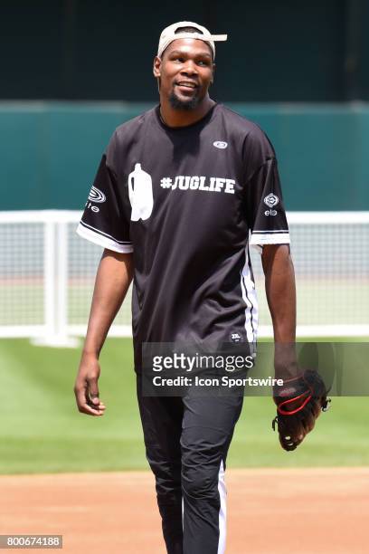 Golden State Warriors Kevin Durant in the field looks on during JaVale McGees JUGLIFE charity softball game on June 24 at Oakland-Alameda County...