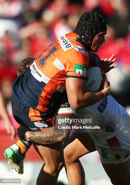 Sione Mata'utia of the Knights is tackled during the round 16 NRL match between the St George Illawarra Dragons and the Newcastle Knights at UOW...