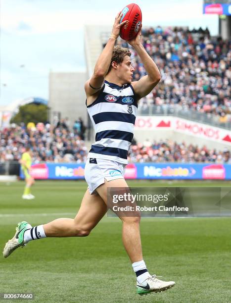 Jake Kolodjashnij of the Cats takes the ball during the round 14 AFL match between the Geelong Cats and the Fremantle Dockers at Simonds Stadium on...