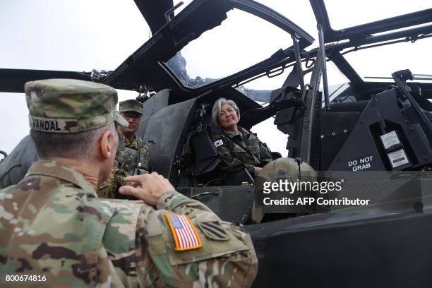 South Korea's Foreign Minister Kang Kyung-Wha talks with Lieutenant General Thomas Vandal , commander of the US 8th Army, as she sits in a AH-64D...