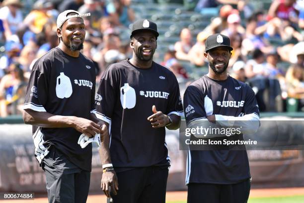 Golden State Warriors Kevin Durant, Draymond Green and Ian Clark look on during JaVale McGees JUGLIFE charity softball game on June 24 at...