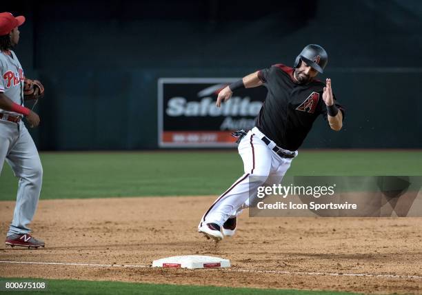 Arizona Diamondbacks left fielder Daniel Descalso rips past third base before scoring on a Chris Hermann double in the seventh inning of the MLB...