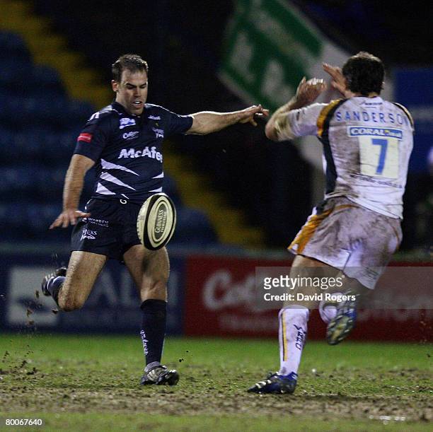 Charlie Hodgson of Sale kicks the ball past Pat Sanderson during the Guinness Premiership match between Sale Sharks and Worcester Warriors at Edgeley...