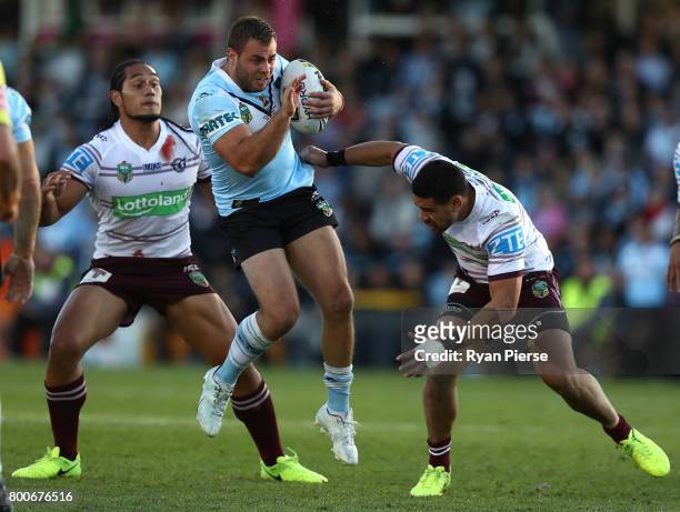 Wade Graham of the Sharks is tackled by Frank Winterstein of the Sea Eagles during the round 16 NRL match between the Cronulla Sharks and the Manly...