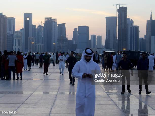 Muslims arrive to perform Eid al-Fitr prayer at Abdul Wahhab Mosque in Doha, Qatar on June 25, 2017. Eid al-Fitr is a religious holiday celebrated by...