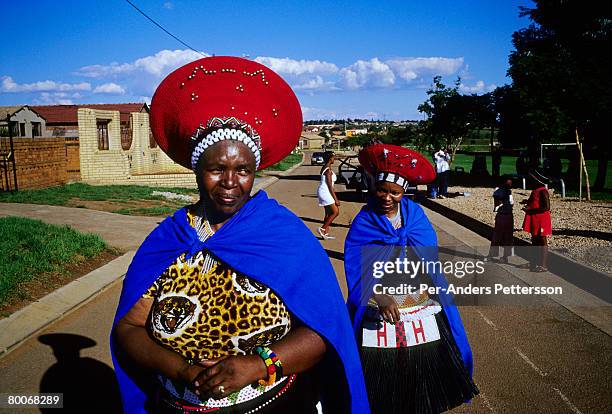 Unidentified Zulu women walk on a street dressed in traditional clothing on March 10, 2005 in Soweto, Johannesburg, South Africa. They have been to a...