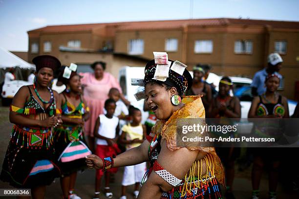 Nondumiso Rakale age 21, dances as she goes through a coming of age ceremony outside her house on December 16, 2006 in Jabulani section of Soweto,...