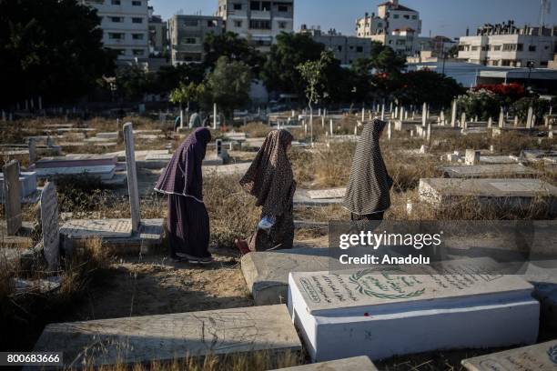 Palestinian Muslims gather to pray at Sheikh Ridvan Cemetery after performing the Eid al-Fitr prayer in Gaza City, Gaza on June 25, 2017. Eid al-Fitr...