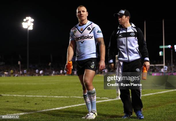 Luke Lewis of the Sharks leaves the ground with an injury during the round 16 NRL match between the Cronulla Sharks and the Manly Sea Eagles at...