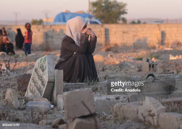 Muslims visit their relatives' tombs at Jarabulus after its cleansing of Daesh militants as part of Operation Euphrates Shield, after they performed...