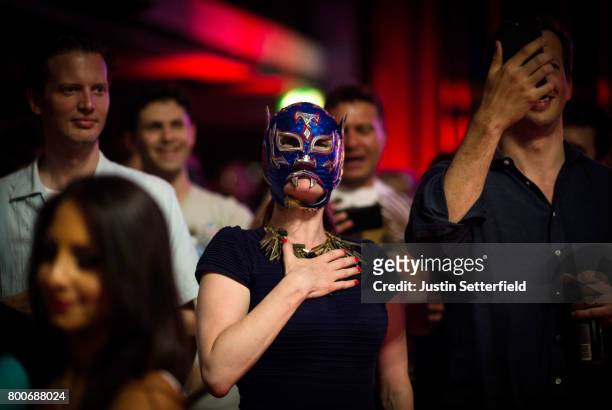 Fan in a mask stands for the national anthem of Mexico ahead of Lucha Libre wrestlers performing at York Hall on June 24, 2017 in London, England....