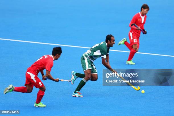 Muhammad Umar Bhutta of Pakistan attempts to break through the China defence during the 7th/8th place match between Pakistan and China on day nine of...