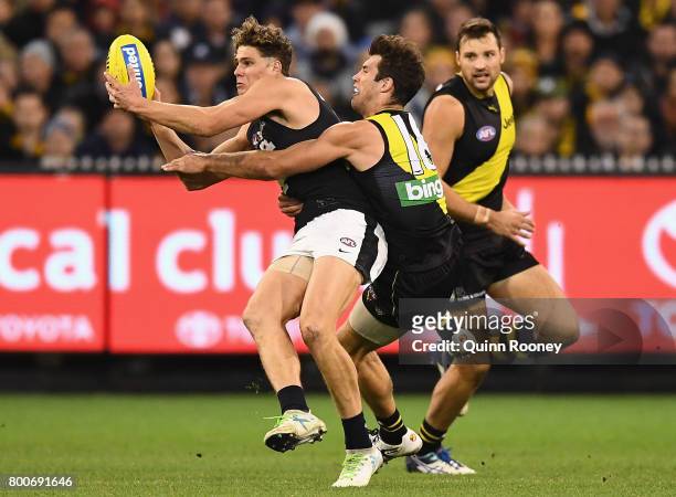 Charlie Curnow of the Blues is tackled by Alex Rance of the Tigers during the round 14 AFL match between the Richmond Tigers and the Carlton Blues at...
